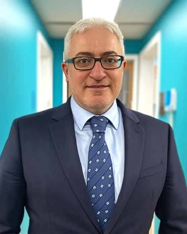 Dentist Flushing NY Aaron Kohan About HP Large Photo Of Dentist Aaron Kohan Smiling In Light Blue Room