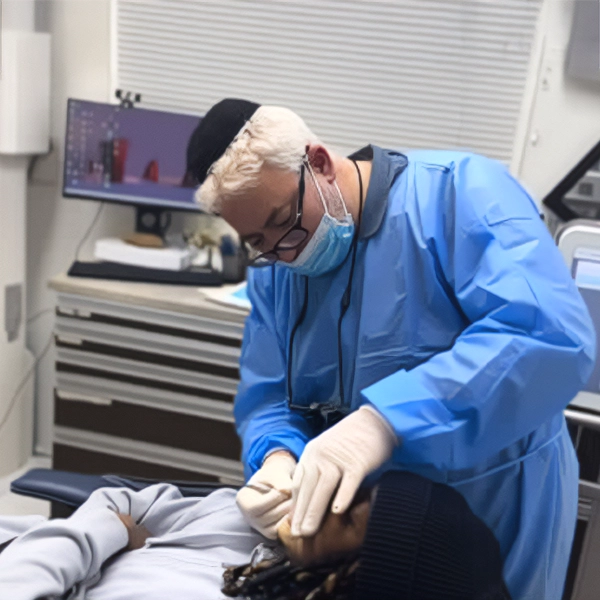 Dentist Aaron Kohan Examining Patient