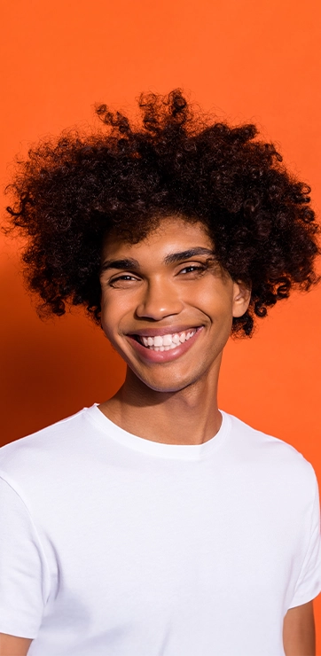 Person With Nice Smile In Front Of Orange Background