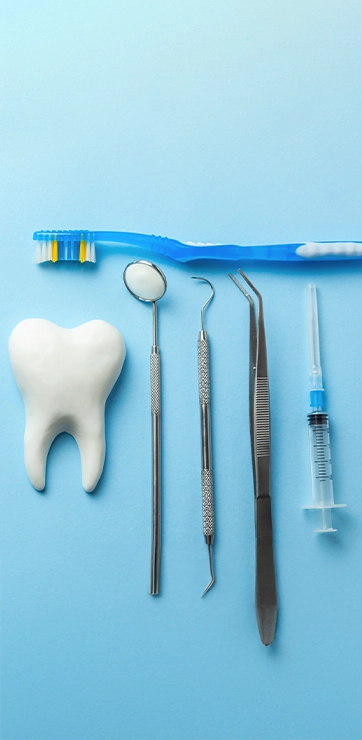 Various Dental Tools Laid Out On A Blue Background